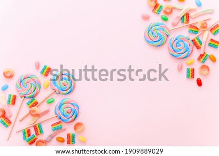 Mixed collection of colorful candy, on pink background. Flat lay, top view