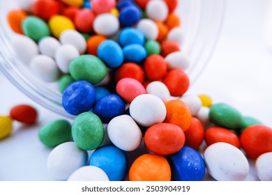 Mixed collection of colorful coated candy spilled out from the jar on isolated white background, milk chocolate, good for article - Powered by Shutterstock