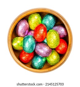 Mixed Colored Foil Wrapped Chocolate Easter Eggs, In A Wooden Bowl. Mini Chocolate Eggs, Sweet Candy, Wrapped In Aluminum Foil Of Different Colors. Isolated From Above, Over White, Macro Food Photo.