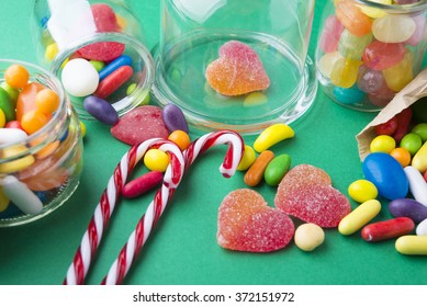 Mixed colorful fruit candies and jellies on green background - Powered by Shutterstock