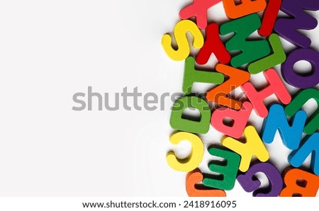 mixed of colorful wooden look alphabet isolated on white background. conceptual photo out of mixed wooden colorful English Letters on a white background. empty copy space for inscription