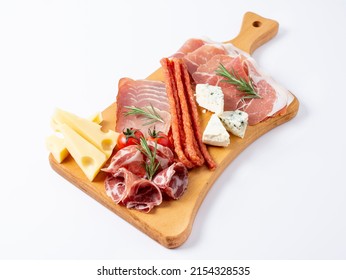 Mixed delicatessen with charcuterie and cheese board with a place for text. Italian appetizers or antipasto set with gourmet food on wooden cutting board isolated on white background. - Shutterstock ID 2154328535