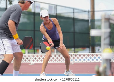 A mixed doubles team competes in a pickleball tournament