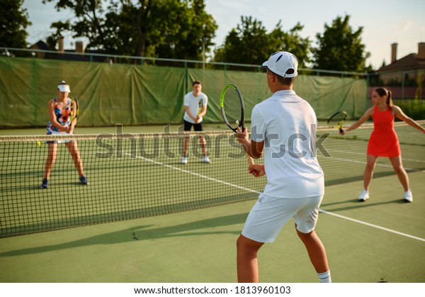 Mixed doubles\
tennis training, outdoor\
court
