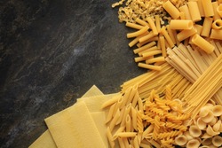 Colorful Pasta, Loop Noodles, Italian Pasta, Farfalle, Fusilli, Penne and  Others on a White Tablet Against a Neutral Background. Stock Photo - Image  of carbohydrates, decoration: 162951908