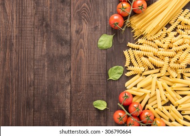 Mixed dried pasta selection on wooden background. - Powered by Shutterstock