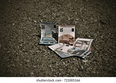 The Mixed Euro Banknotes Lying On The Sand Ground. The Concept Of Lost Money.