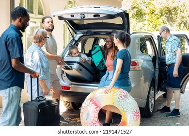 Mixed family and friends going on holiday, preparing vehicle with bags and luggage to go on summer vacation. Multiethnic people travelling on journey adventure with baggage in automobile. - Powered by Shutterstock