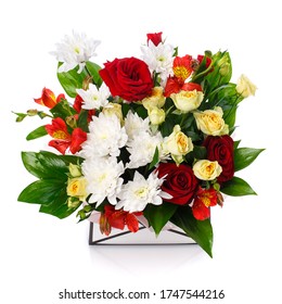 Mixed flower arrangement on white background. Roses, daisies and green leaves in a box. Celebration concept.