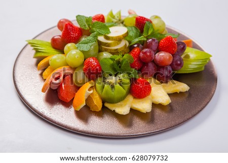 Mixed Fruit platter with assorted fruits on a white background.