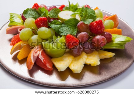 Mixed Fruit platter with assorted fruits on a white background.