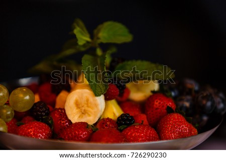 Mixed Fruit platter with fork strawberries blackberries pineapple and watermelon