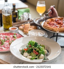 Mixed Green Salad with Mozzarella Cheese and Sun Dried Tomatoes. Dinner at Italian Restaurant - Powered by Shutterstock