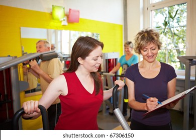 Mixed Group Doing Circuit Training In A Gym