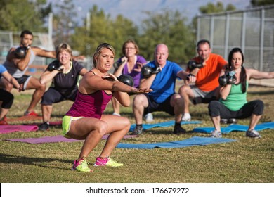 Mixed group of people doing a boot camp exercise class - Powered by Shutterstock