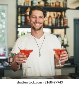 Mixed Just For You. Portrait Of A Happy Young Bartender Holding Two Cocktails While Standing Behind The Bar.