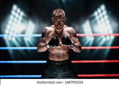 Mixed martial artist posing in the ring against spotlights. Concept of mma, ufc, thai boxing, classic boxing. Mixed media