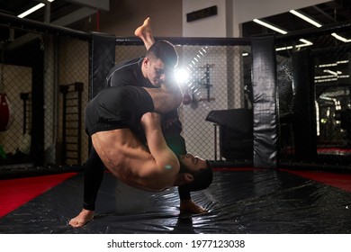 Mixed martial artists punching each other, fighting without rules at gym, training. aggressive boxers sparring, having strong powerful muscles - Powered by Shutterstock