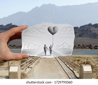 Mixed media image showing a hand-held piece of paper with a sketch on it depicting a walking couple with the woman holding a big heart shaped balloon, with a rocky landscape in the photo background