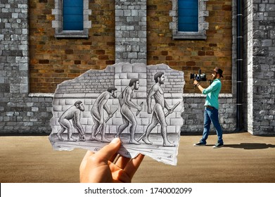 Mixed media image showing a hand-held piece of paper with a pencil drawing depicting man evolution from the primitive monkey to the modern man with photographer and walls in the photo background - Shutterstock ID 1740002099