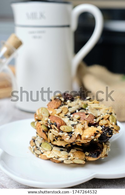 Mixed Nut and\
Dried fruits and Seeds Florentine, Gluten free whole foods Healthy\
biscuit cookies. set on cafe\
table.