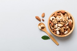 Mixed Nuts In Bowl. Mix Of Various Nuts On Colored Background. Pistachios, Cashews, Walnuts, Hazelnuts, Peanuts And Brazil Nuts.