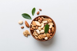 Mixed Nuts In Bowl. Mix Of Various Nuts On Colored Background. Pistachios, Cashews, Walnuts, Hazelnuts, Peanuts And Brazil Nuts.