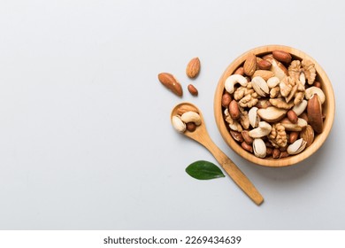 mixed nuts in bowl. Mix of various nuts on colored background. pistachios, cashews, walnuts, hazelnuts, peanuts and brazil nuts. - Shutterstock ID 2269434639