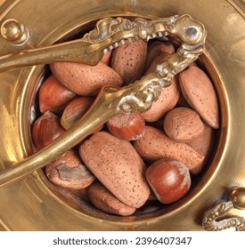 Mixed nuts with vintage nutcracker, isolated on white