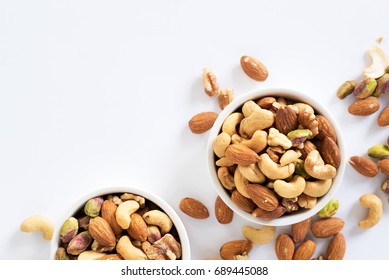 mixed nuts in white ceramic bowl  - Shutterstock ID 689445088