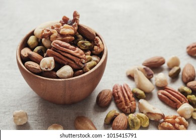 Mixed nuts in wooden bowl, healthy fat and protein food, vegan, ketogenic diet, plant based diet, natural sources of tryptophan for getting good sleep and relaxation