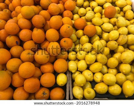 Mixed of orange and lemon on sheld at supermarket . It have vitamin C, antioxident, good for body. Selective focus, may have grain and noise.