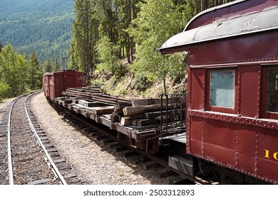 A Mixed Passenger and Freight Train on a Mountain Side Track - Powered by Shutterstock