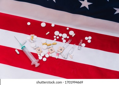 Mixed Pills On US Flag With The Inscription USA. Coronavirus In The USA. US Healthcare