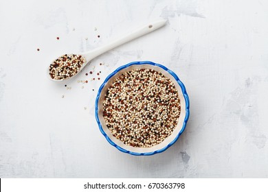 Mixed quinoa in bowl on stone kitchen background top view.