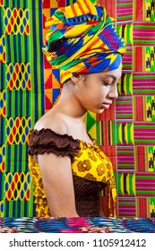 Mixed race african american female model wearing traditional west african fashion on a african fabric background