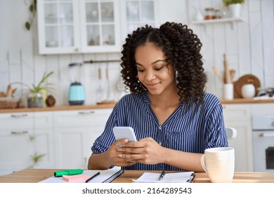 Mixed Race African American Teen School Girl Distant School Or College Student Holding Smartphone Virtual Remote E Learning Using Cell Phone App. Mobile Technology For Online Education At Home.