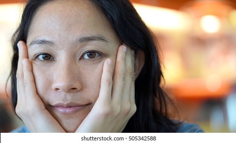 Mixed Race Asian Woman Looking At Camera With Natural Skin Tone With No Make Up