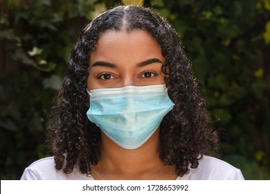 Mixed Race Biracial Teenager Teen Girl Young Woman Wearing A Face Mask During The Coronavirus COVID-19 Virus Pandemic