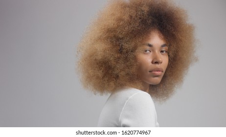 Mixed Race Black Woman With Big Blonde Afro Hair Turned To The Camera