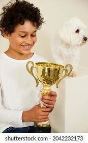 Mixed Race Boy With His Coton De Tulear Cotton Dog Winning 1st Price In A Dog Show 