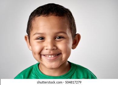 Mixed Race Boy Smiling Portrait Child In Studio