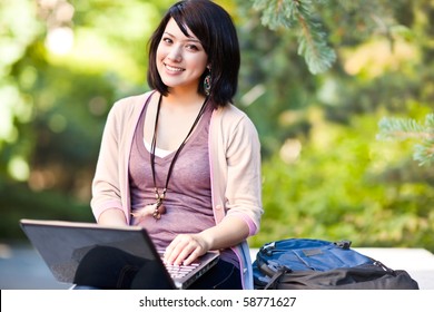 Mixed Race College Student Working On Laptop At Campus