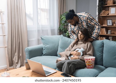 Mixed race couple African American man and white woman, male massage his girlfriend or wife in her menstrual period while sitting at home. Love, support and respect in relationship or marriage concept - Powered by Shutterstock