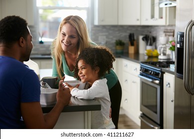 Mixed Race Couple And Daughter Talk Together In The Kitchen