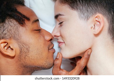 Mixed Race Couple Having An Intimate Moment On The Bedroom. Lifestyle At Home. Young People.