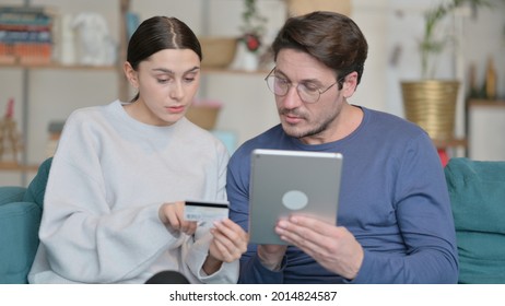 Mixed Race Couple Shopping Online On Tablet