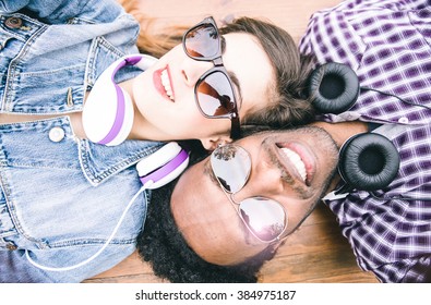 Mixed Race Couple Taking Self Portrait Lying Down On The Floor