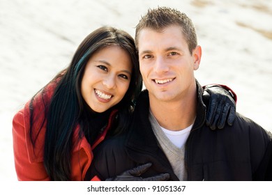 Mixed Race Couple In Winter Snow