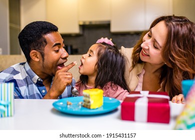 Mixed Race Family Habing Birthday Party In Kitchen